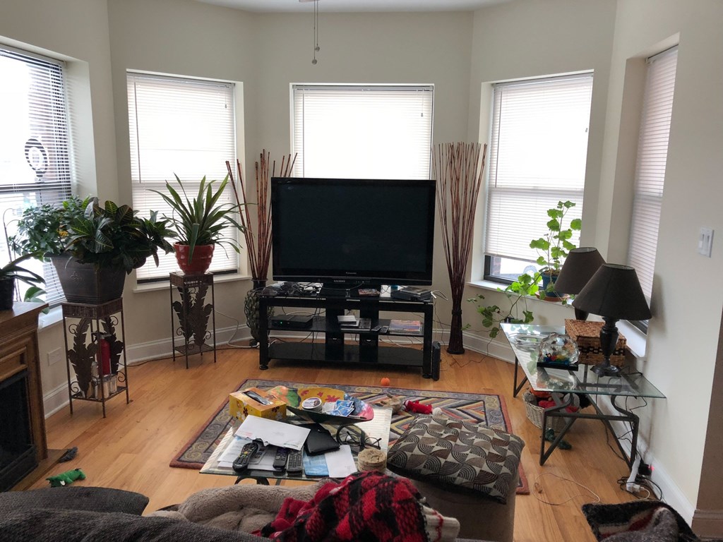 a living room with a tv in the center of it