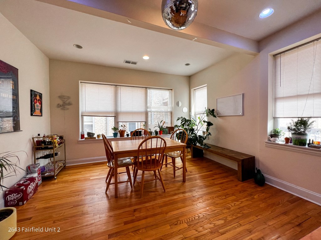 a dining room with a table and chairs and a large window