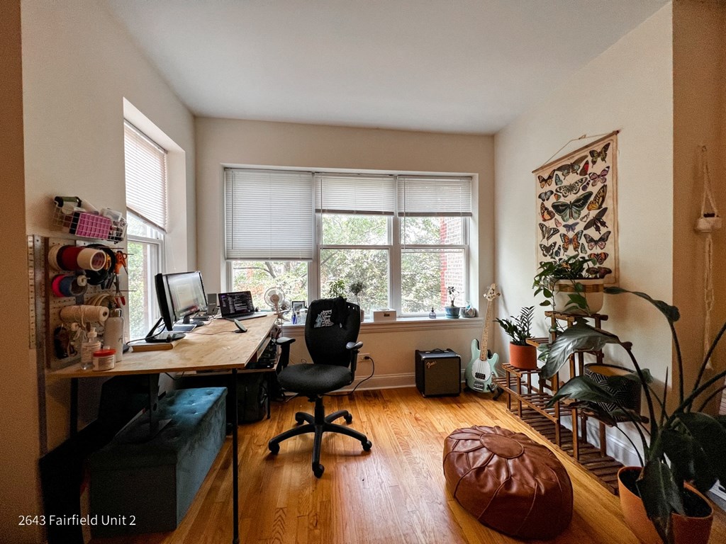 a home office with a desk and a window