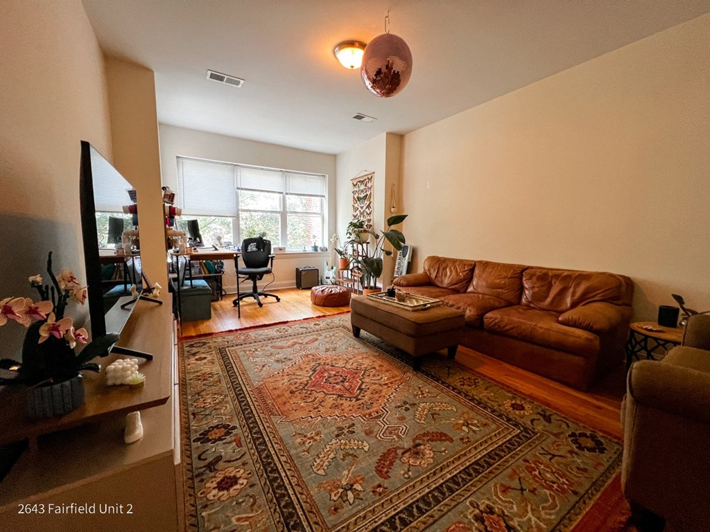 a living room with a couch and a rug
