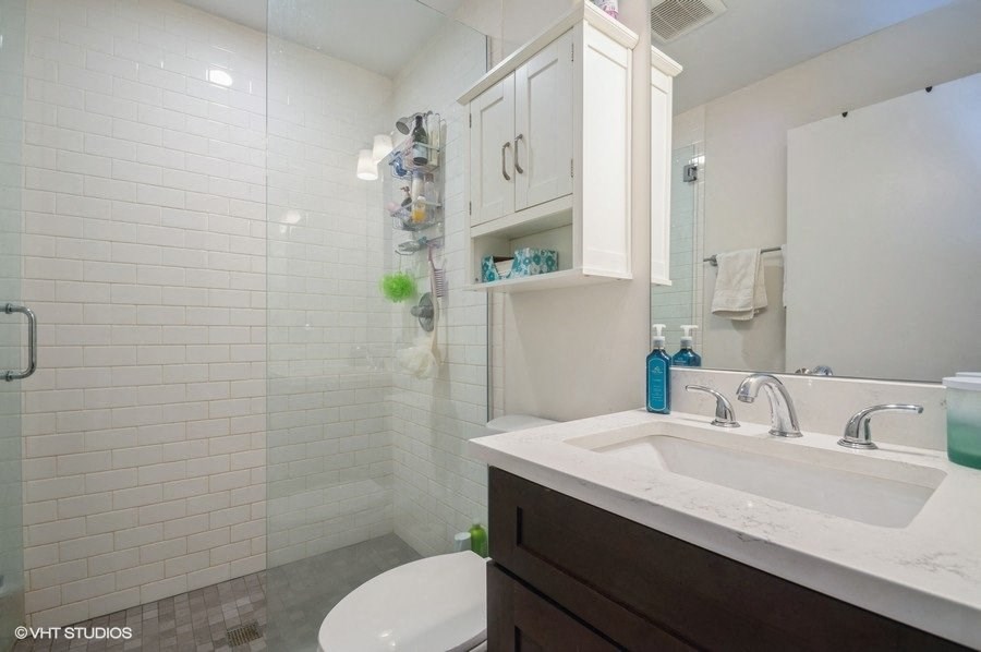 a bathroom with a sink and a toilet and a shower