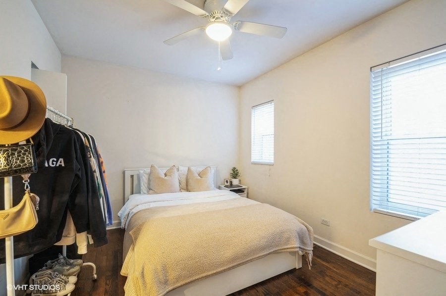 a bedroom with a bed and a ceiling fan