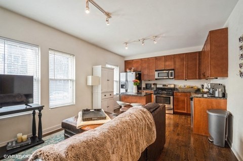 a living room with a couch in front of a kitchen