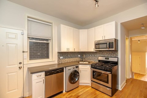 a kitchen with stainless steel appliances and white cabinets