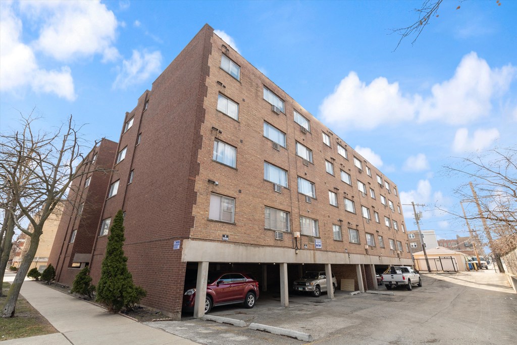 a large brick building with a parking lot in front of it