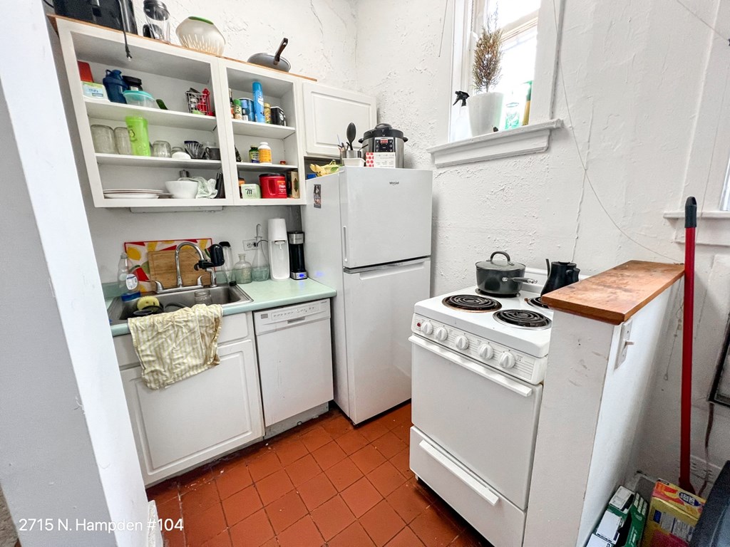 a small kitchen with a stove refrigerator and sink