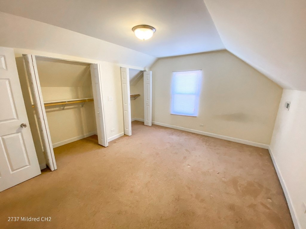 a bedroom with a closet and a window