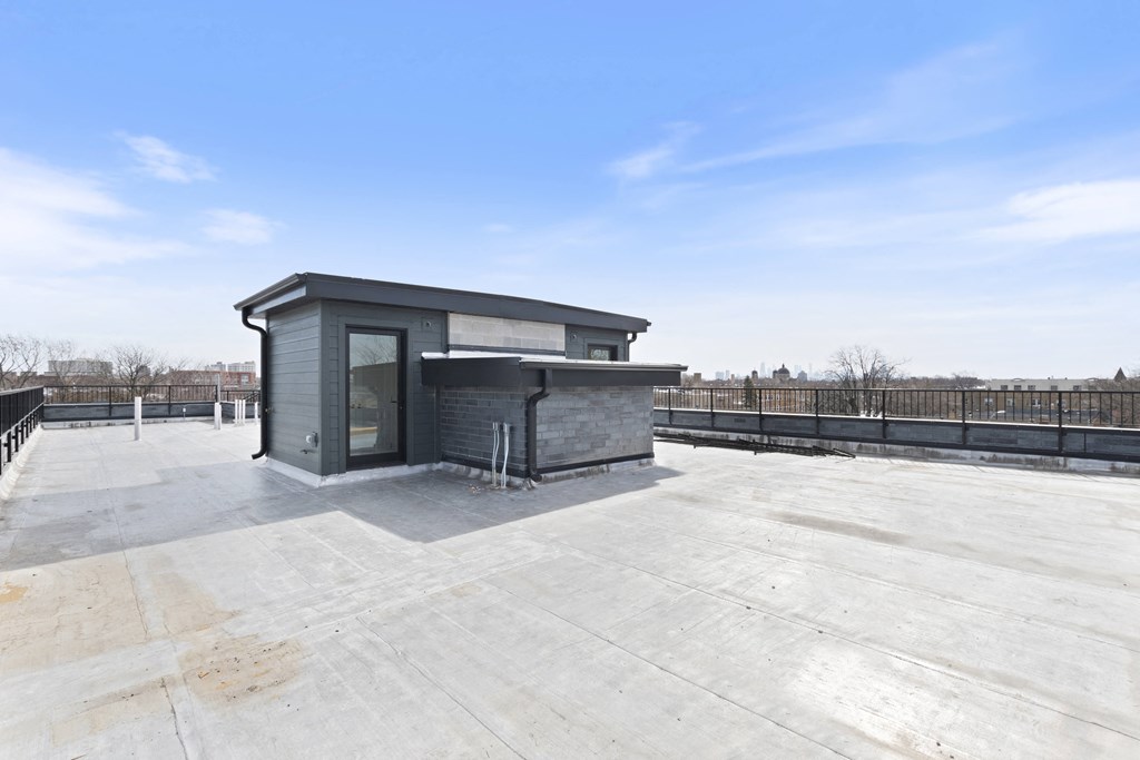 the roof deck has a small cabin with a hot tub on it