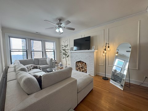 A living room with a fireplace and a large couch.
