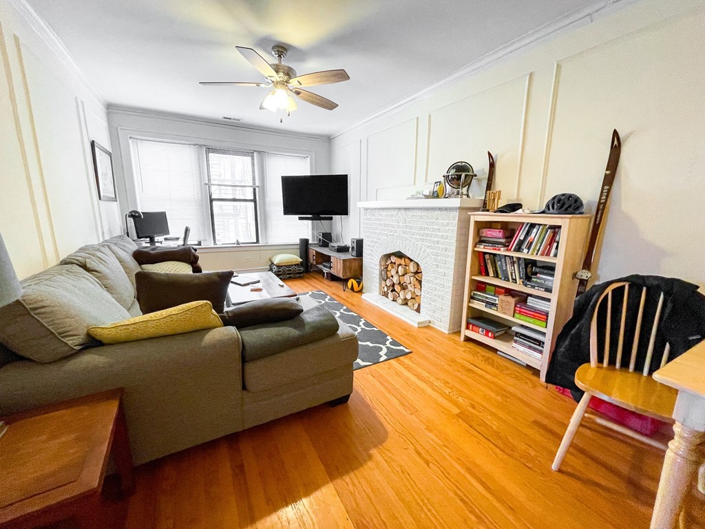a living room with a couch and a ceiling fan