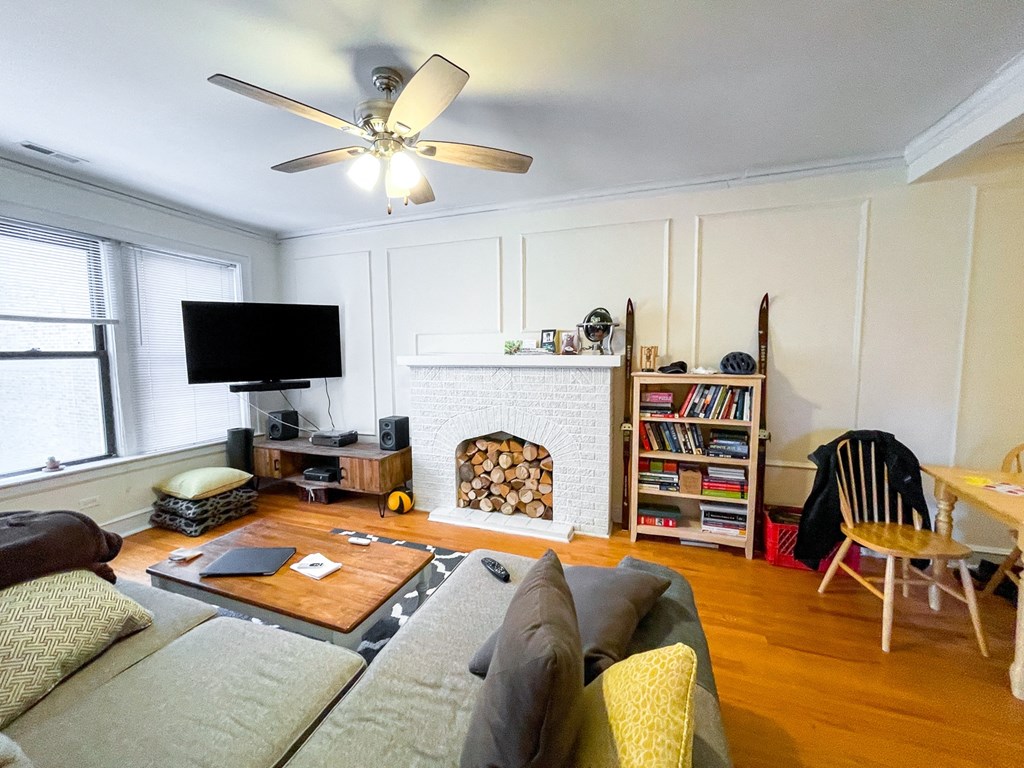 a living room with a couch and a ceiling fan
