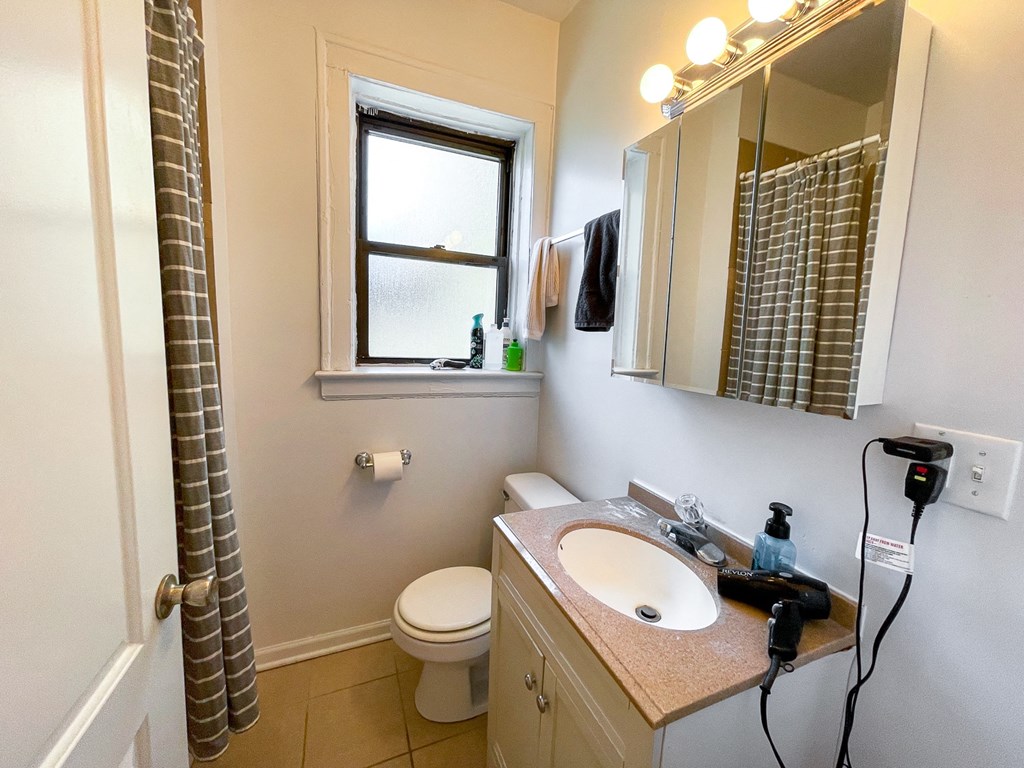 a bathroom with a shower and a sink and a toilet