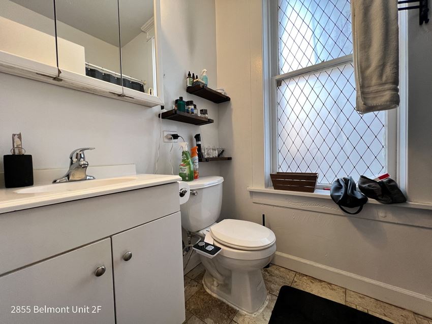 a small bathroom with a toilet sink and window
