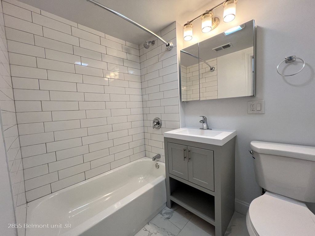 a bathroom with a sink toilet and a bath tub