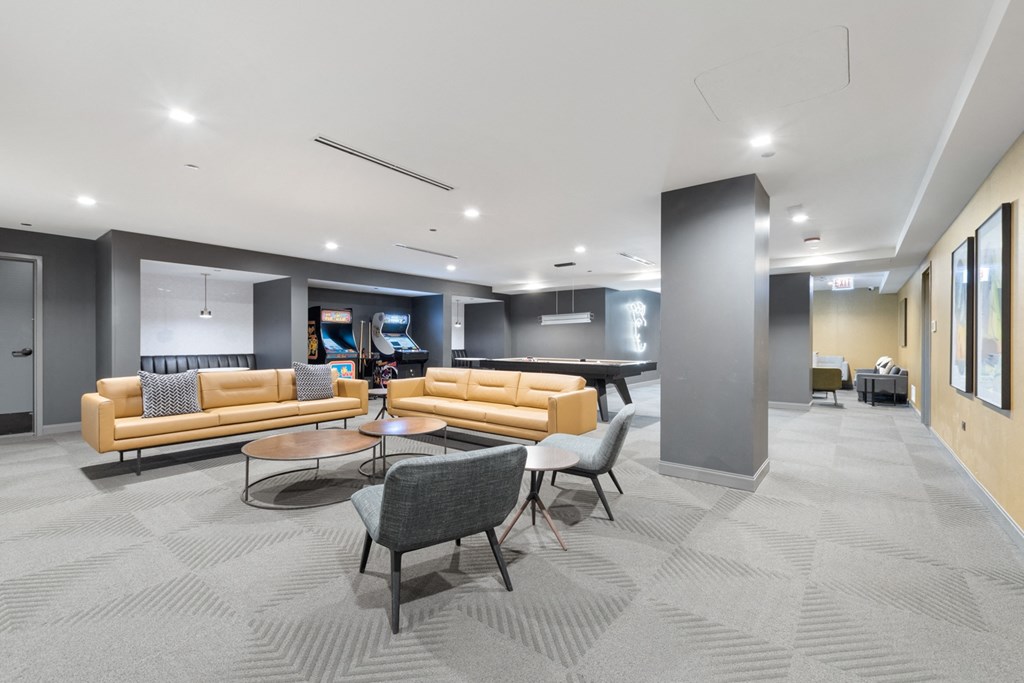 a common room with couches chairs and a pool table