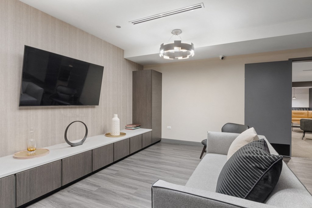 a living room filled with furniture and a flat screen tv