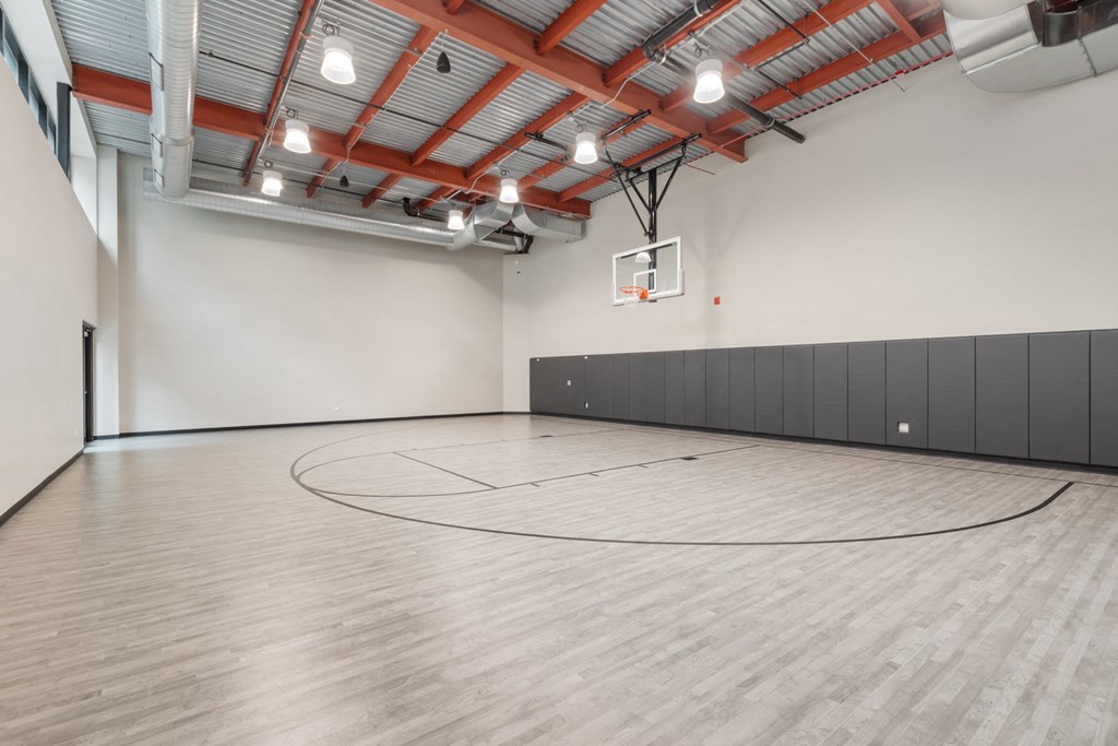 the inside of a gym with a basketball hoop