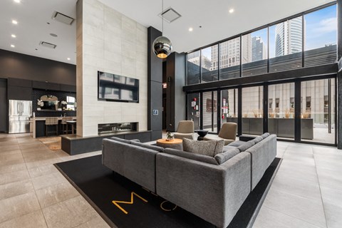 a living room with a gray couch and a large window
