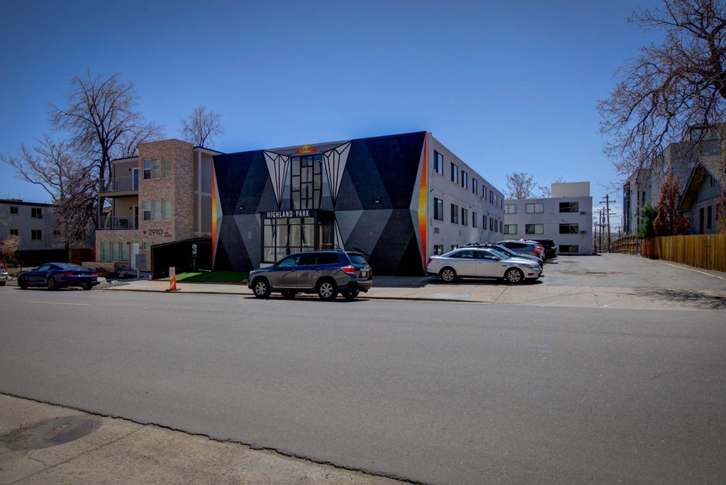 a building with a geometric design on the side of a street
