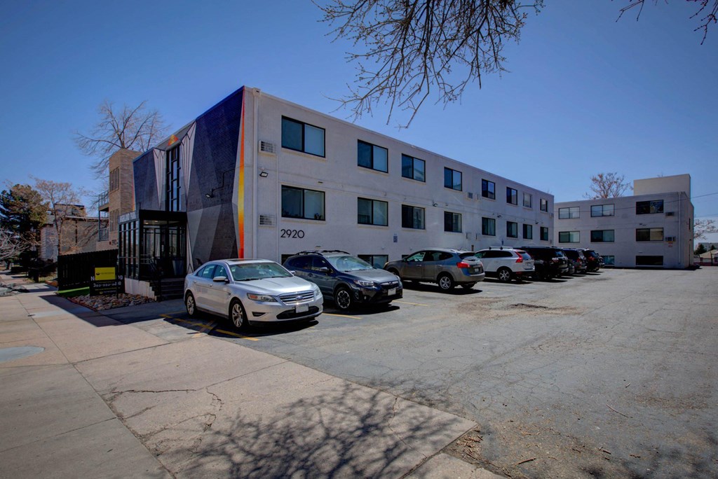 a large building with cars parked in front of it