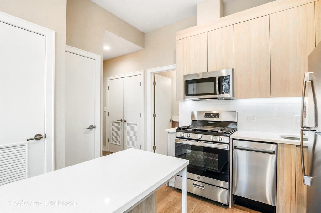 a kitchen with wooden cabinets and stainless steel appliances