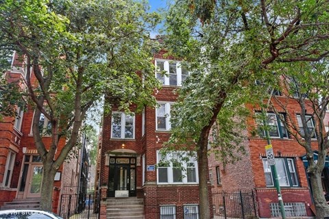 a red brick building with trees in front of it