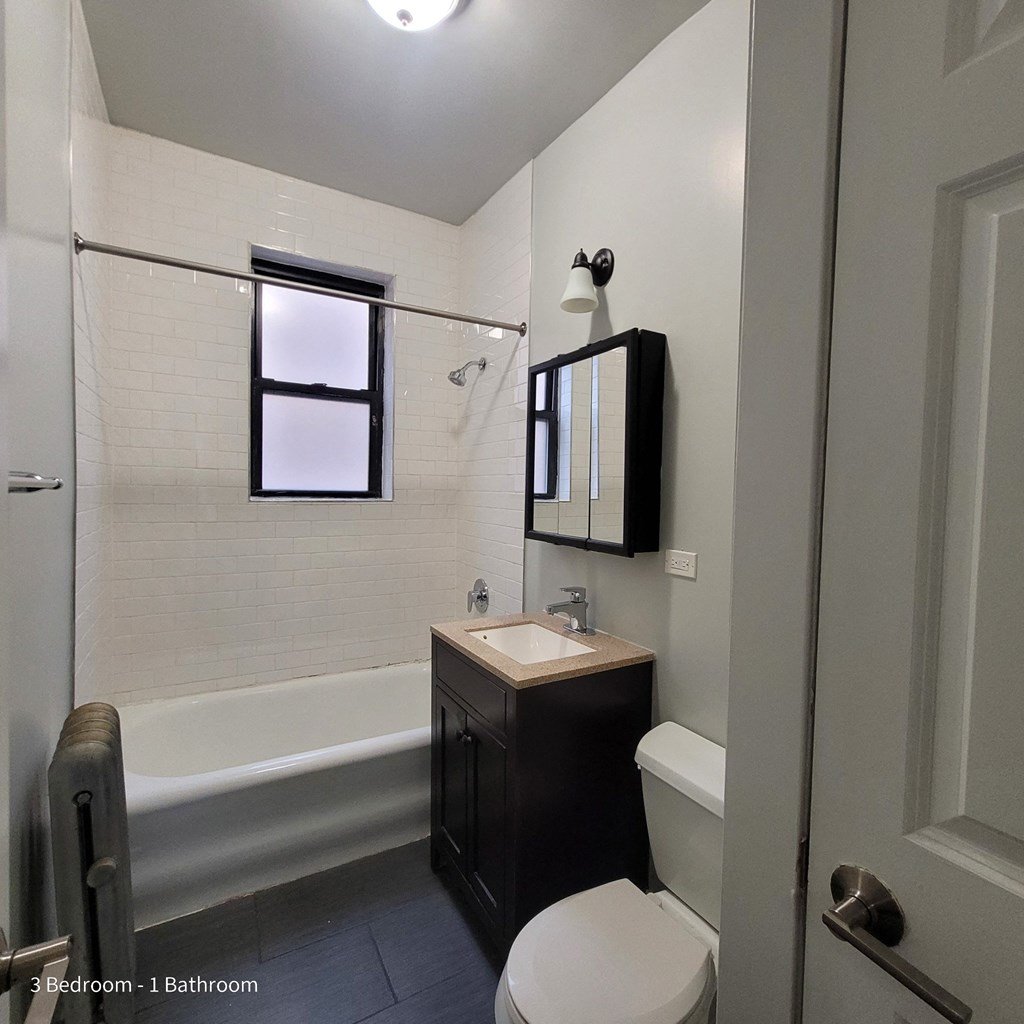 a small bathroom with a sink toilet and bath tub