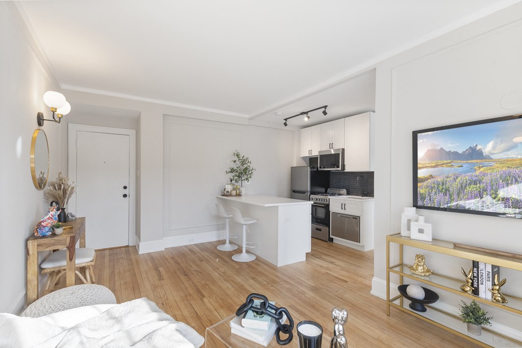 a living room with a couch and a table and a kitchen