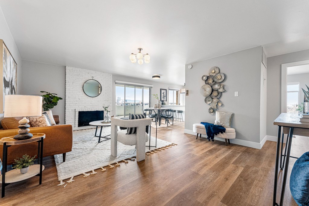 a living room with a fireplace and a dining room table