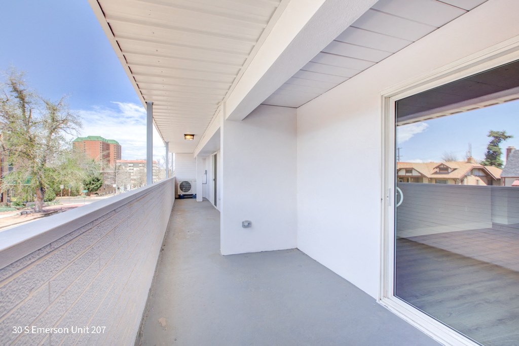 a large balcony with a view of the city