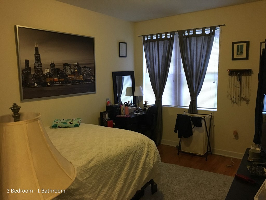 a bedroom with a bed and a picture of the city