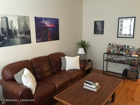 a living room with a leather couch and a coffee table