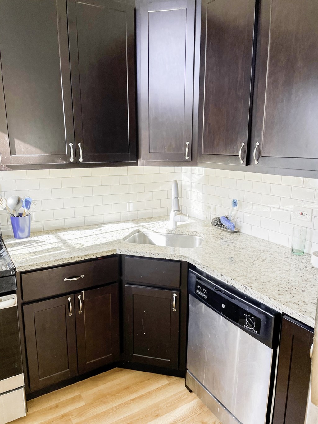 a kitchen with black cabinets and a counter top and a sink