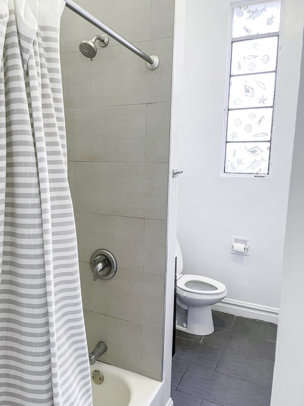 a small bathroom with a shower and a toilet