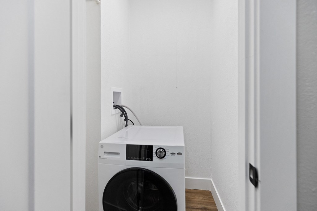a small laundry room with a washing machine and a sink