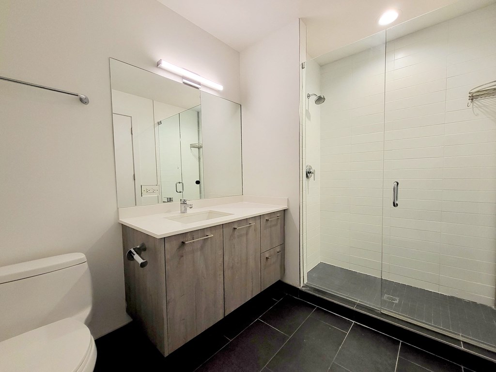 a bathroom with a toilet sink and shower