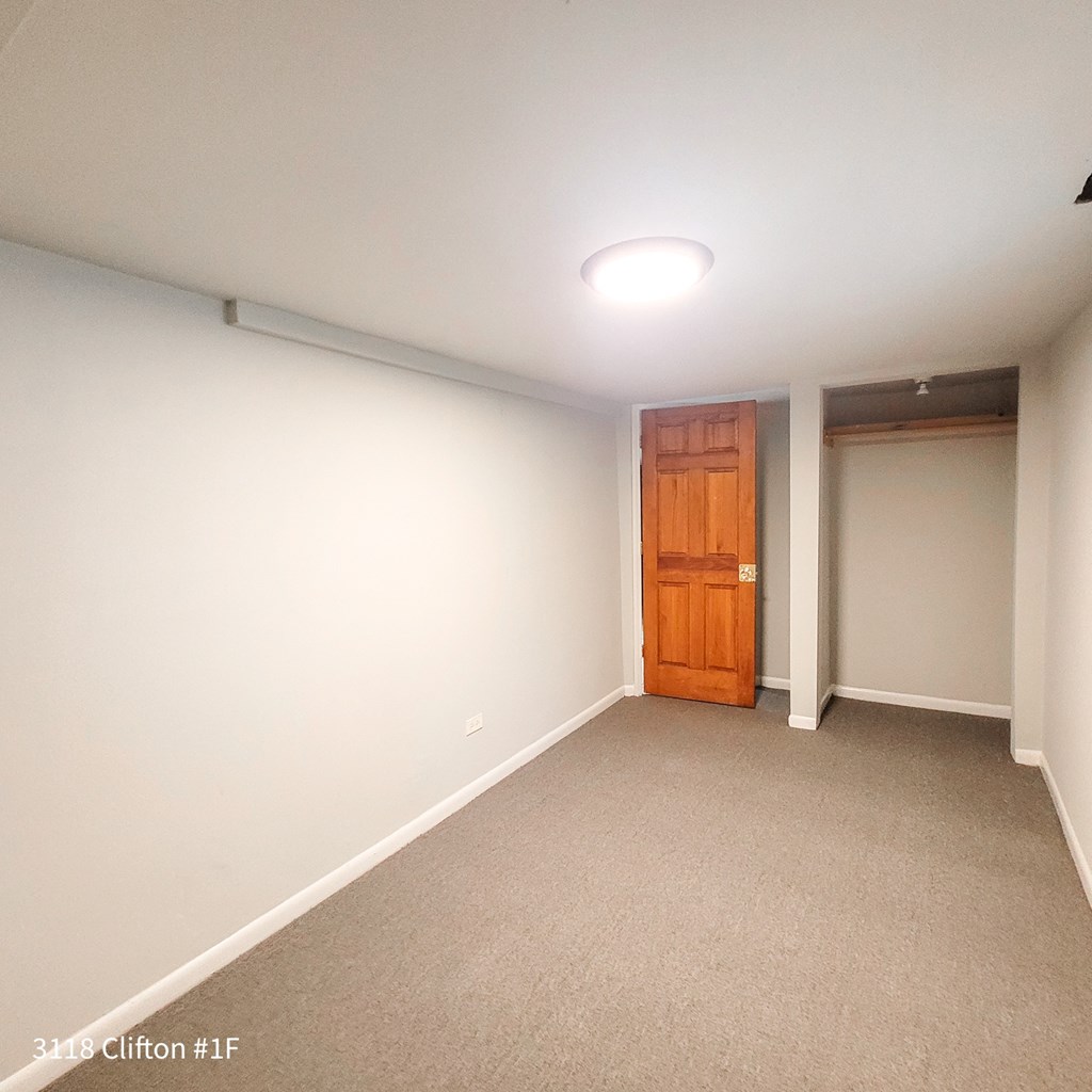 a white room with a wooden door and a white wall