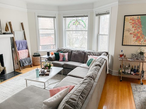 A living room with a grey couch and a coffee table.