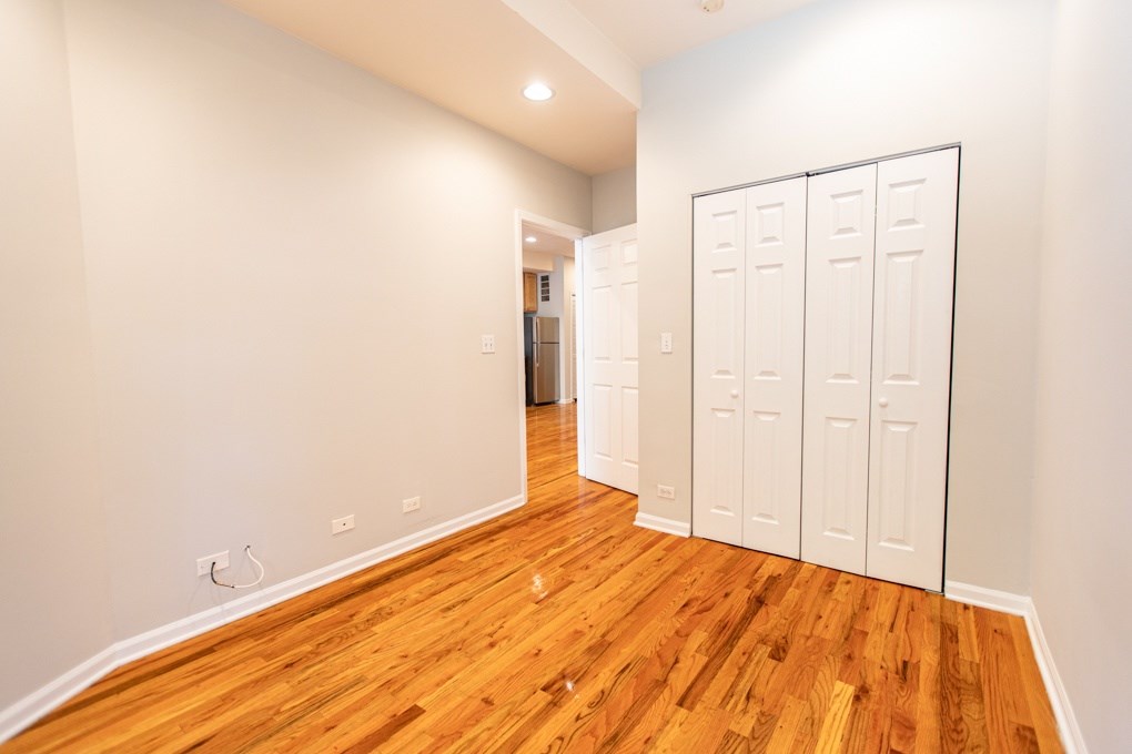 A room with wooden floors and white walls.
