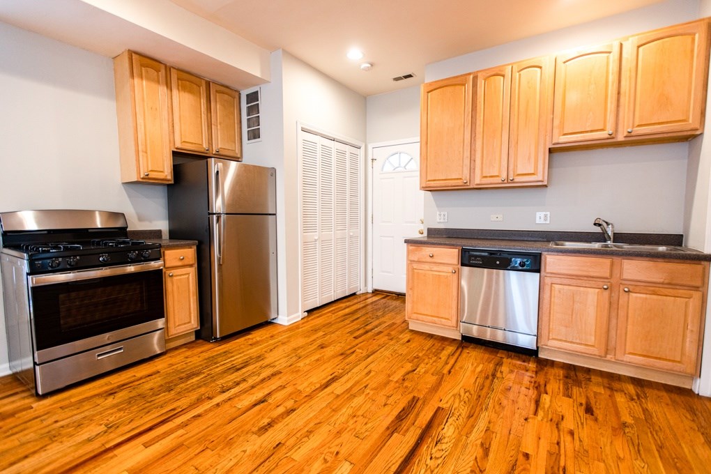 A kitchen with wooden cabinets and stainless steel appliances.