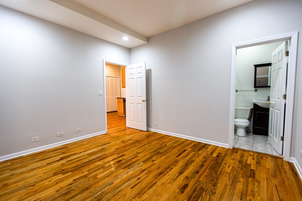 A room with wooden floors and white walls.