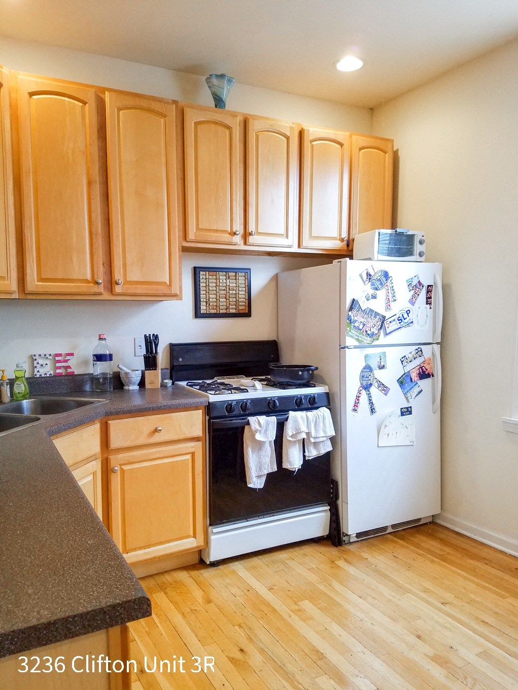 a kitchen with a stove refrigerator and cabinets