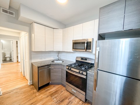 a kitchen with stainless steel appliances and a refrigerator