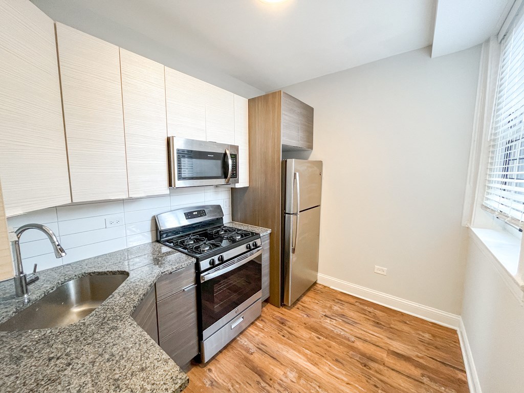 a kitchen with stainless steel appliances and a granite counter top