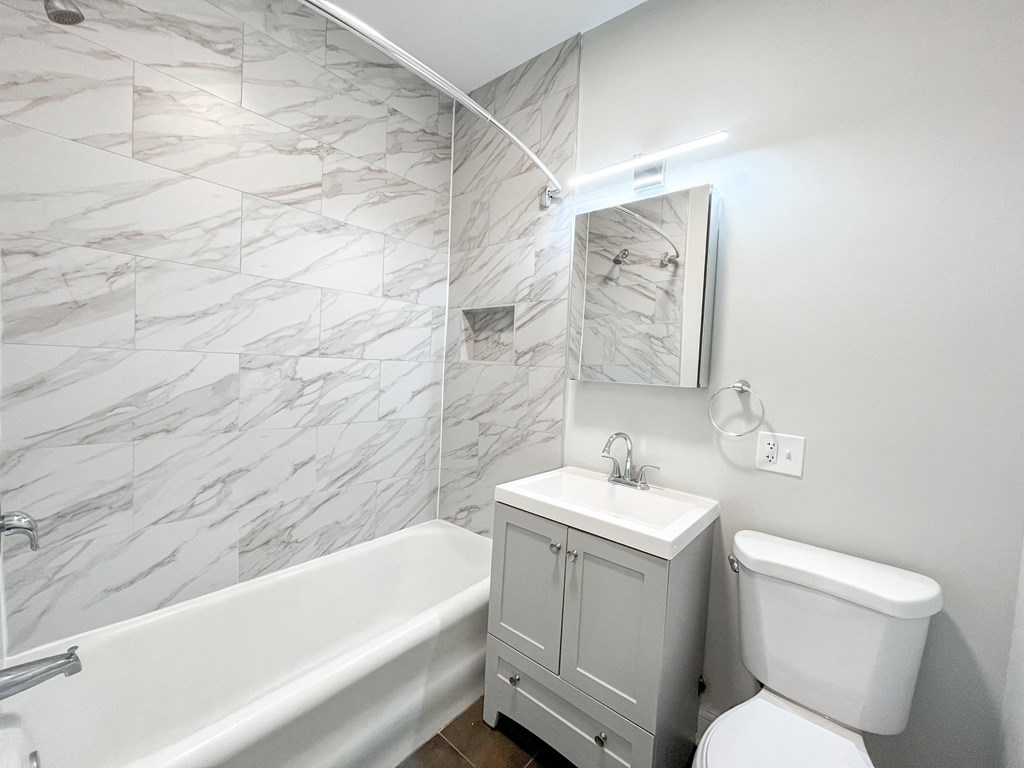 a bathroom with a sink toilet and a bath tub