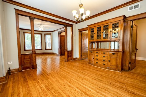 A large room with wooden floors and furniture.