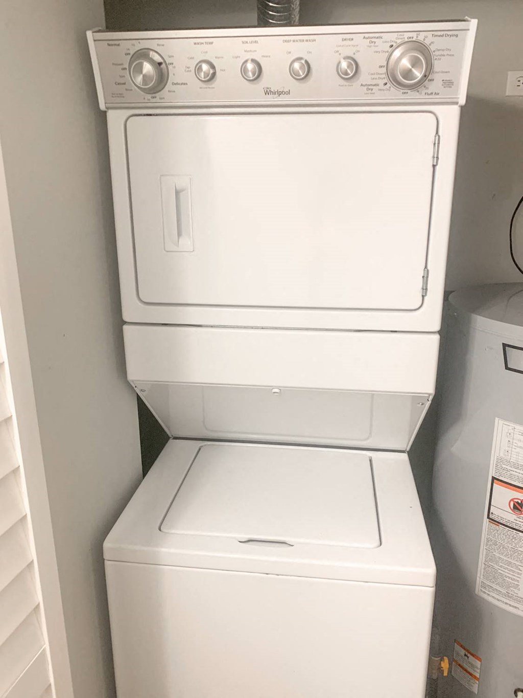 a white washer and dryer in a closet