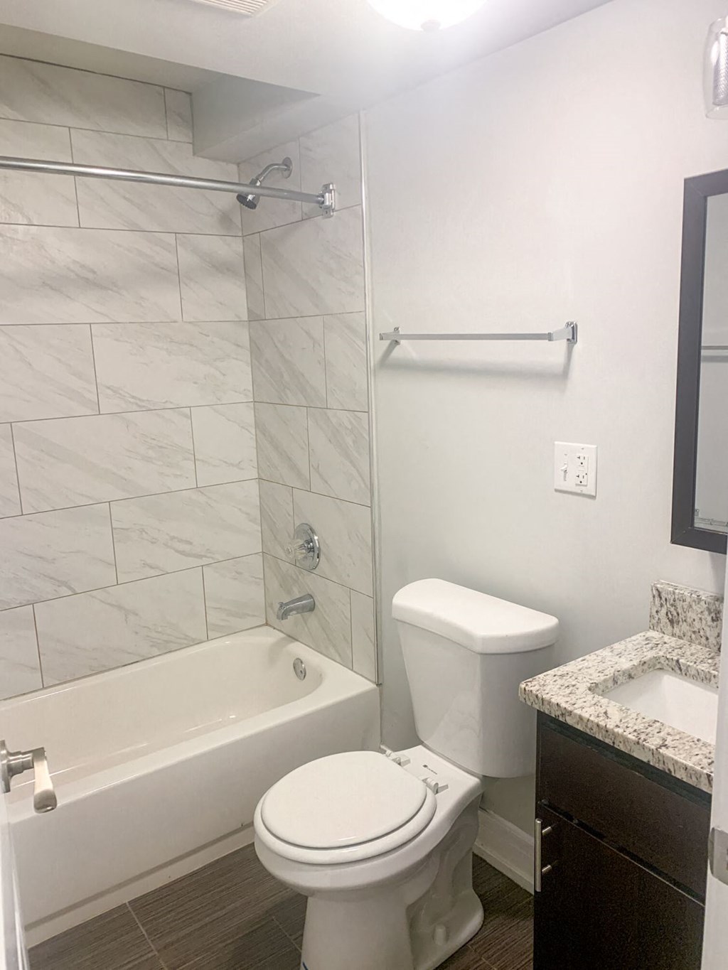 a bathroom with a toilet and a tub and a sink