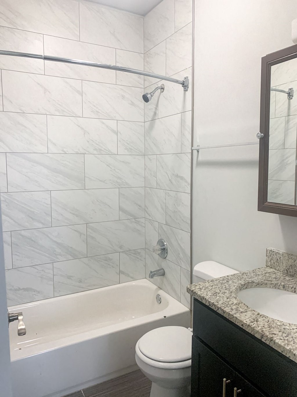 a bathroom with a shower and a sink and a toilet