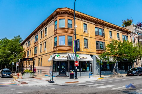 a large brick building on the corner of a city street